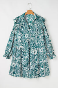 Robe turquoise à imprimé floral, col V avec boutons, dos et manches longues sur cintre.