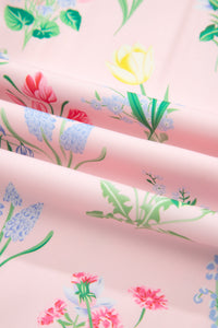 Tissu rose à fleurs multicolores et feuillages verts, motifs botaniques.