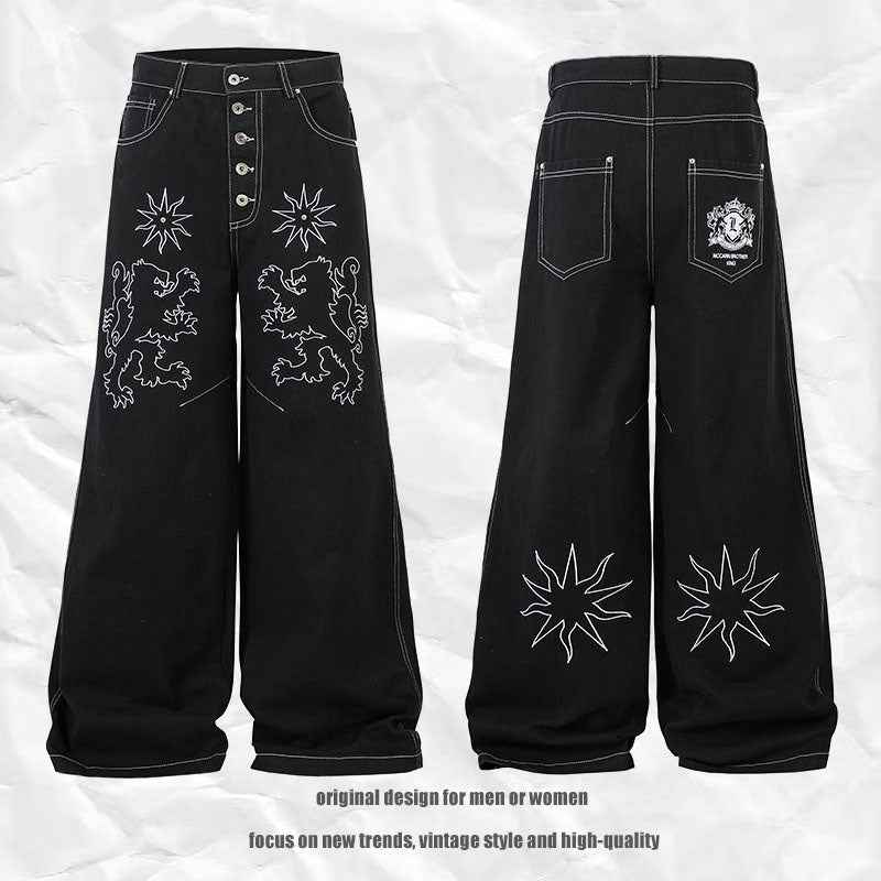Pantalon jean femme noir large, broderies florales sur l’avant et l’arrière, jambe droite.