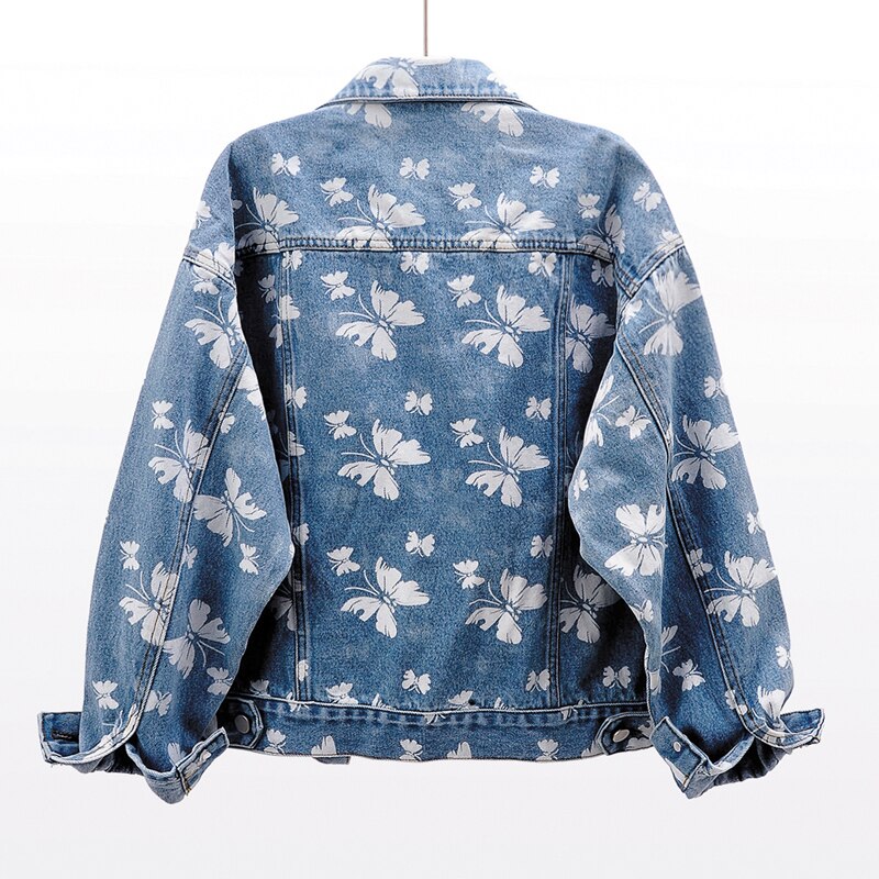 Veste en jean bleue pour femme, dos motif floral blanc, fermeture boutonnée et col