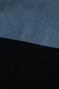 Haut polo bicolore en denim, empiècement supérieur bleu et base noire.