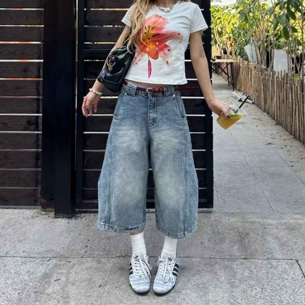 Jean femme bleu clair ample à taille haute, poches devant visibles, délavage vintage.