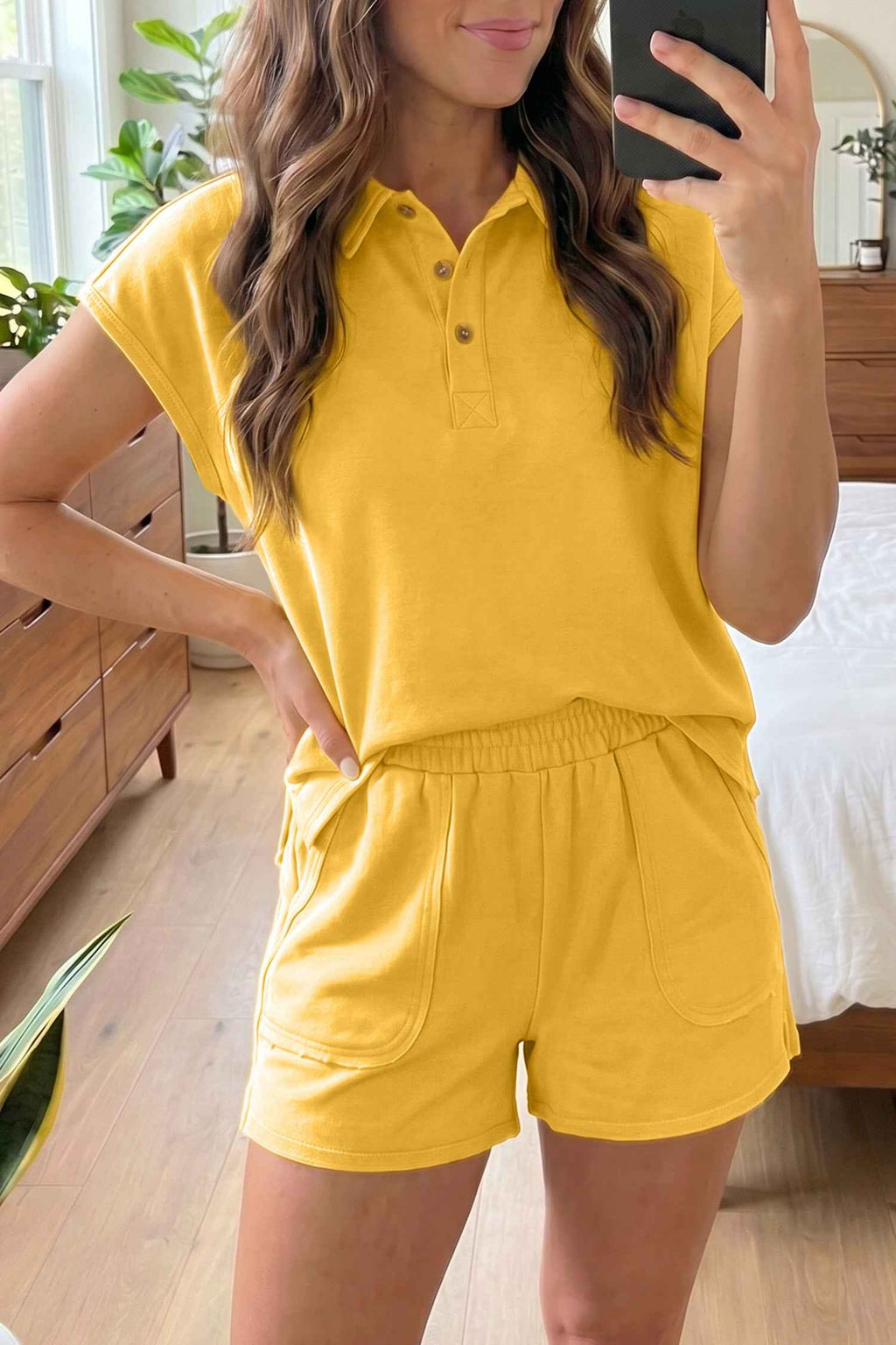 Ensemble polo et short pour femme jaune à manches courtes, col boutonné et taille élastique.