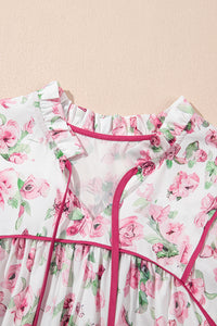 Robe motif floral rose, encolure froncée avec rubans et bord fuchsia