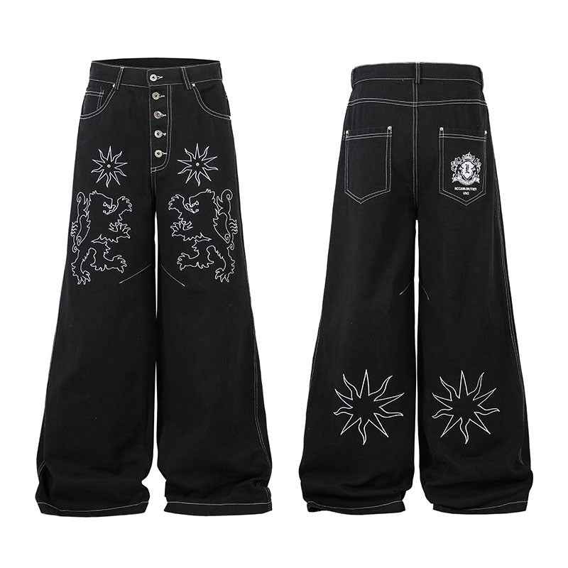 Pantalon jean femme noir, broderies florales sur l’avant et les poches arrière, jambe droite.