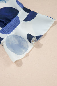Bas de robe blanche à pois bleu, fente et bordure de manchettes