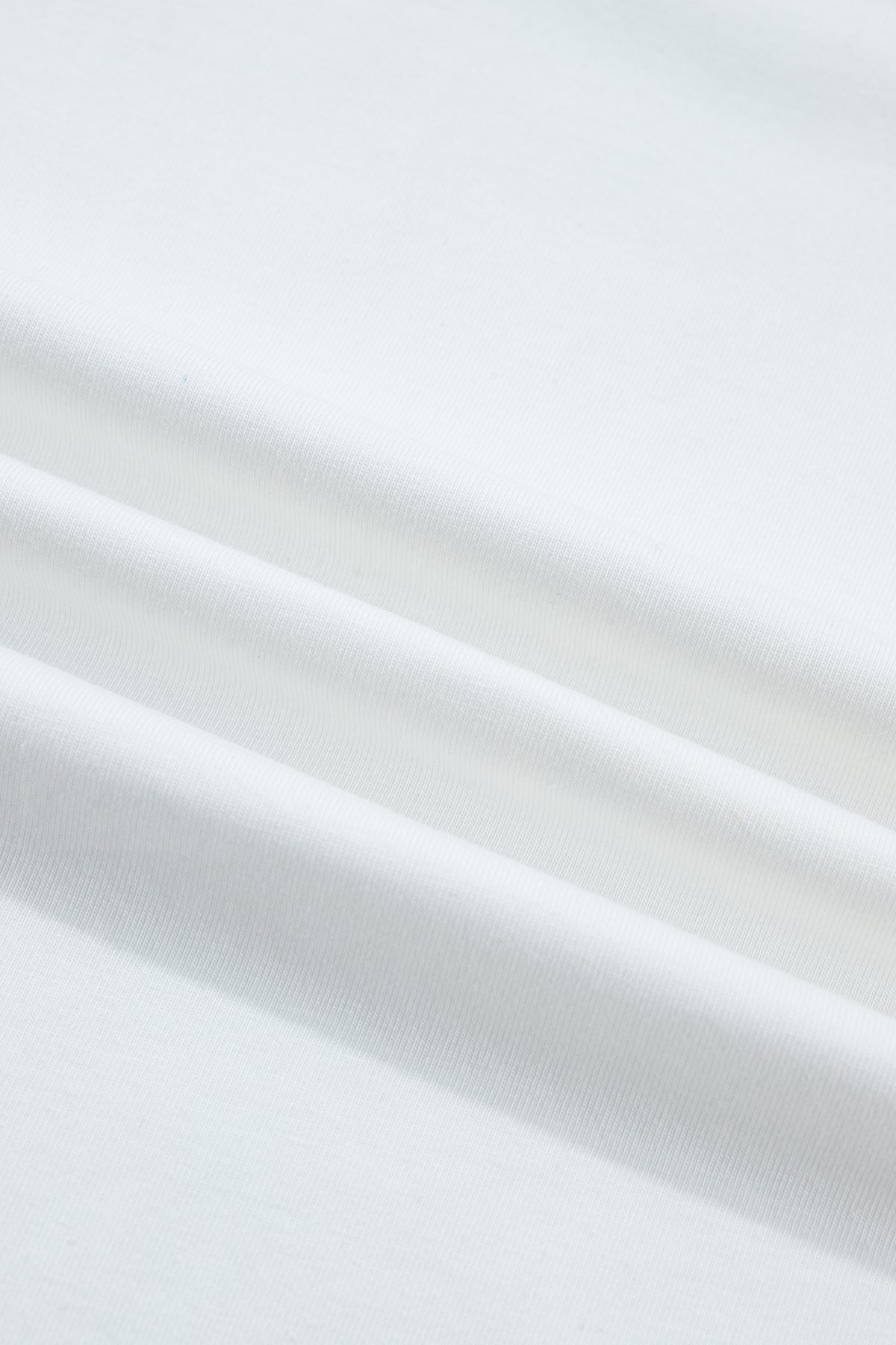Tissu de haut femme blanc en coton, surface lisse et légère