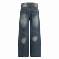 Jean femme bleu taille mi-haute, poches arrière et coutures contrastées.