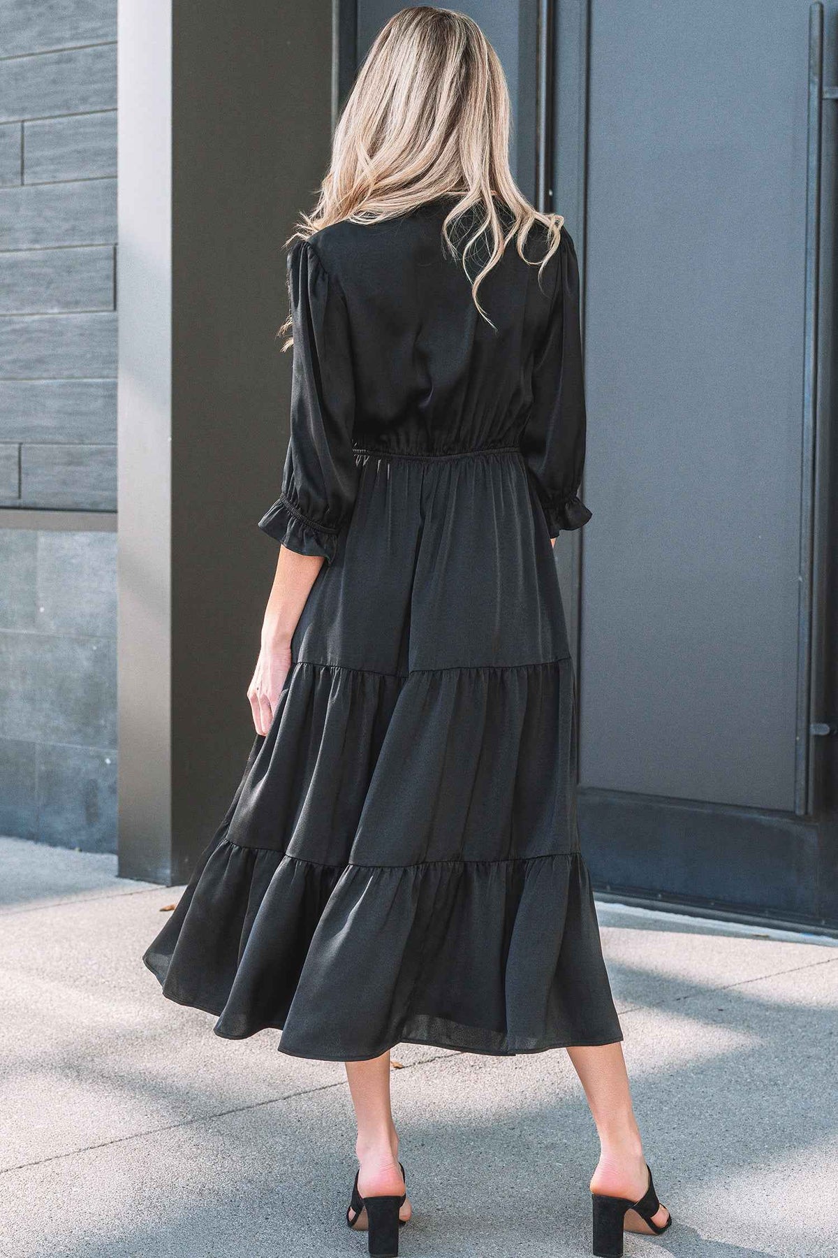 Robe maxi noire à volants étagés, encolure en V au dos, coupe évasée.