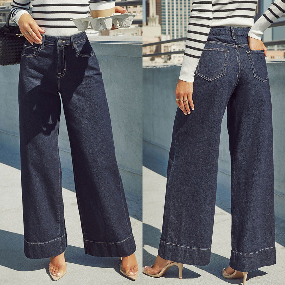 Jean taille haute bleu marine à jambe ample, poches devant, surpiqûres visibles