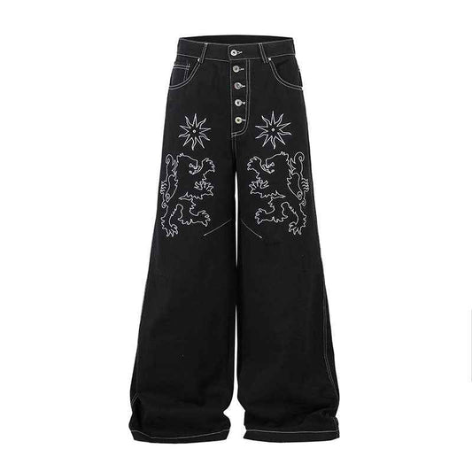 Pantalon jean femme noir à broderie florale, taille boutonnée et poches avant.