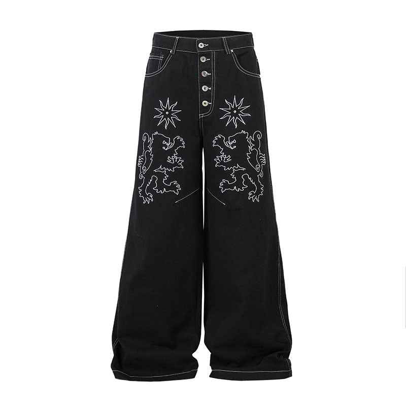 Pantalon jean femme noir à broderie florale, taille boutonnée et poches avant.