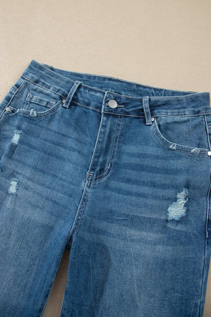 Jean taille haute en denim bleu moyen, poches et boutons, effet délavé