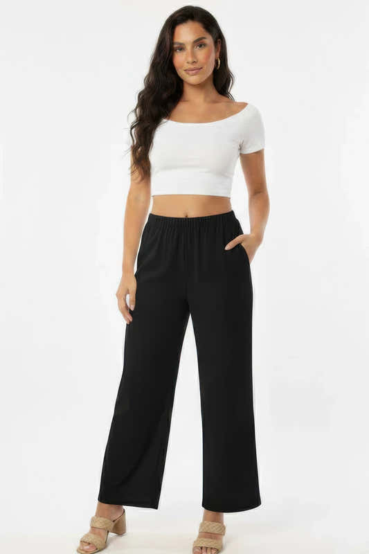 Pantalon large noir en coton, taille élastique et poches latérales.