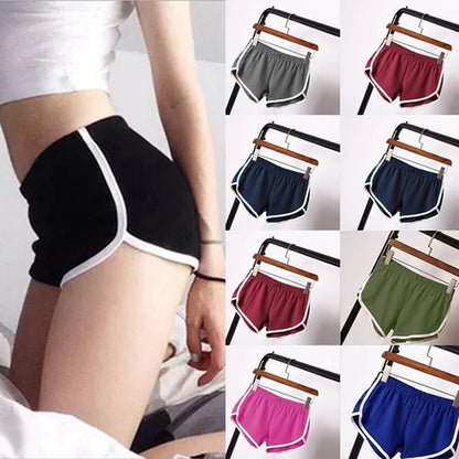 Short sport femme noir à liseré blanc, coupe courte, vue portée et plusieurs coloris.