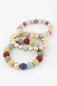 Bracelet perles dorées et cristaux, billes jaune/beige, bleu clair et bordeaux
