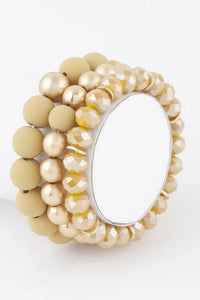 Bracelet perles moutarde et dorées, cristaux beiges, plaque ovale argentée