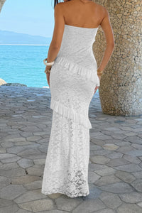Robe longue en dentelle blanche, bustier sans bretelles et volants superposés.