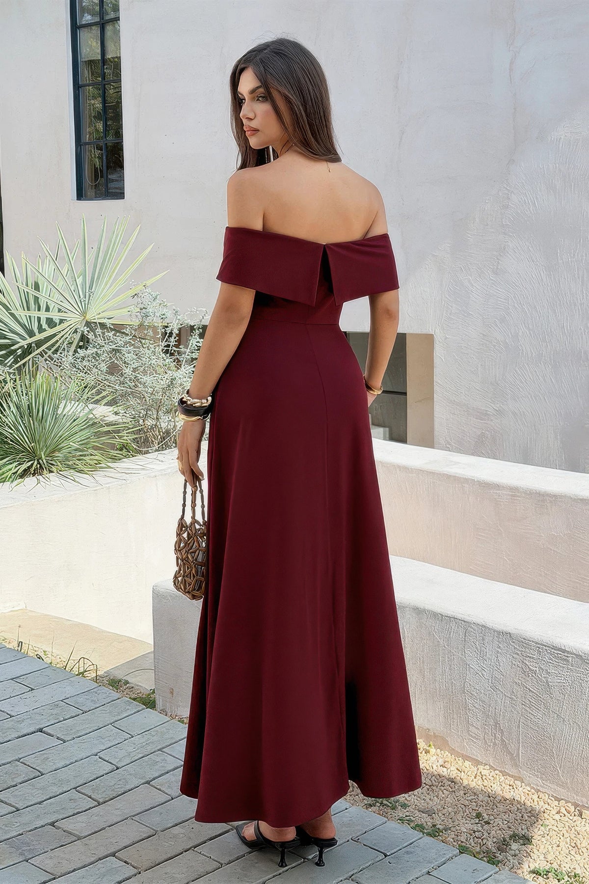 Robe maxi bordeaux à épaules dénudées, dos nu, jupe ample évasée.