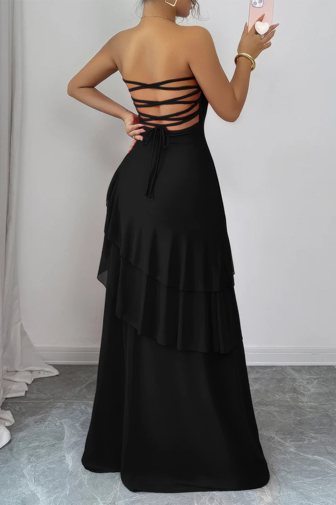 Robe longue noire au dos croisé avec laçage, volants superposés, taille marquée