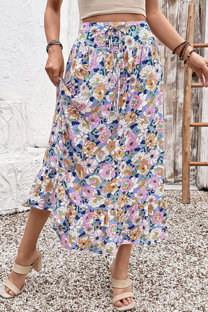 Jupe longue bohème à taille haute, imprimé floral multicolore, fronces et volants.