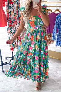 Robe longue verte à fleurs multicolores, volants aux épaules et coupe A-line évasée.