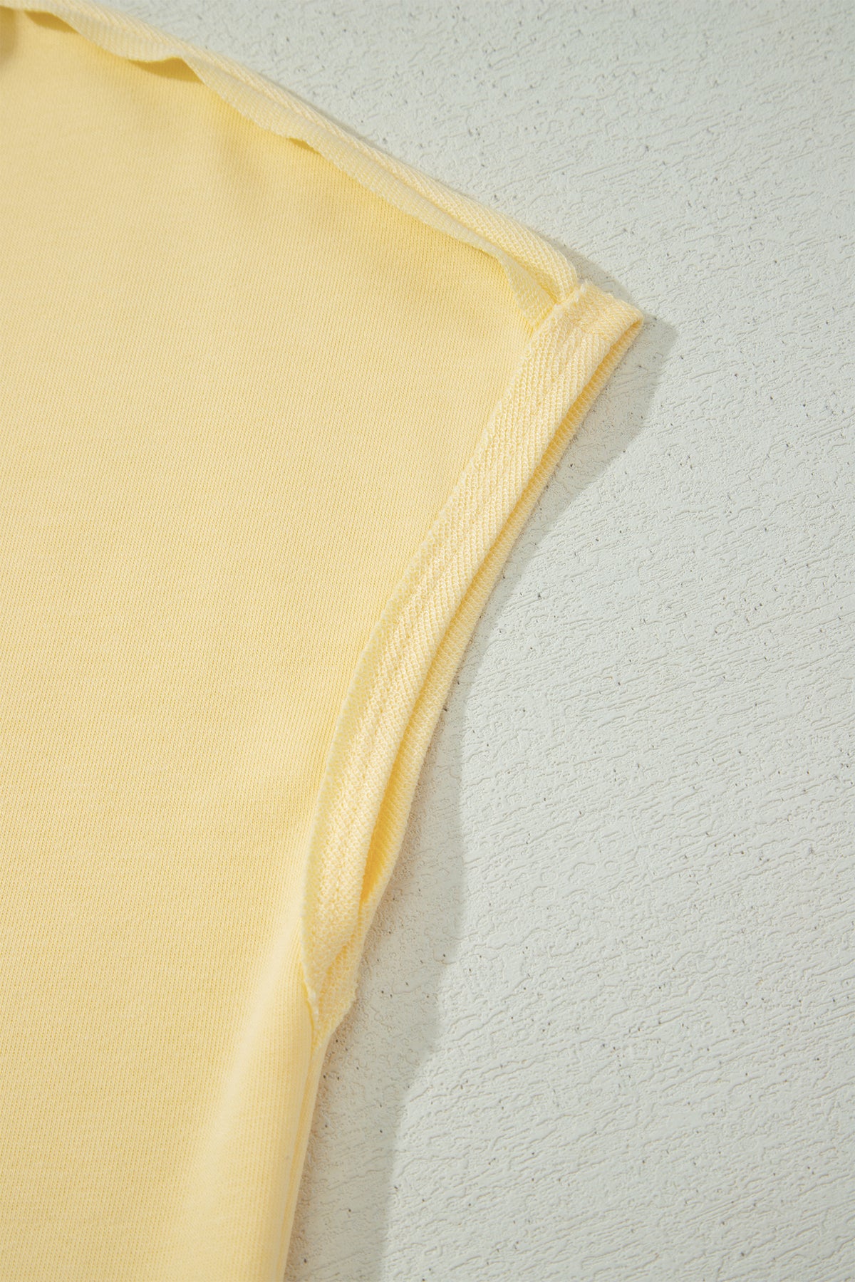 Couture latérale du short jaune crème femme avec passepoil fin