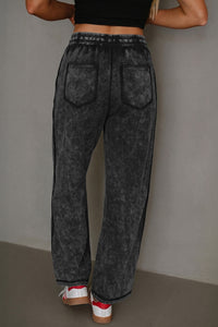 Pantalon ample noir délavé minéral, poches plaquées devant, taille élastique avec cordon