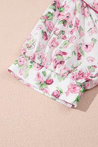 Robe blanche motif floral rose, coupe ample et ourlet évasé