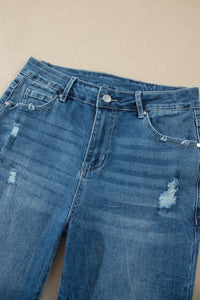 Jean taille haute en denim bleu moyen, poches et boutons, effet délavé