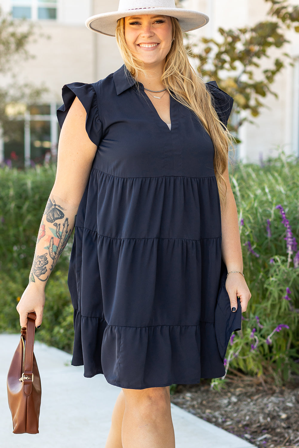 Robe bleue marine à volants superposés, encolure V, manches courtes.