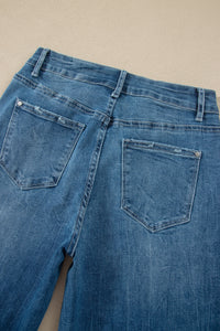 Jean flare taille haute bleu moyen, vue du dos avec poches et boutons.