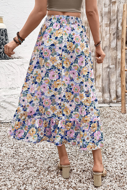 Jupe longue bohème à taille haute, motif floral multicolore, volants à plusieurs niveaux.