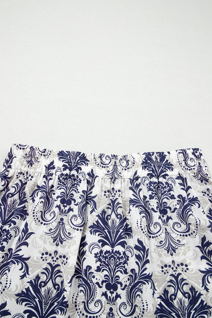 Jupe longue bleu et blanc à imprimé baroque floral, bas froncé.