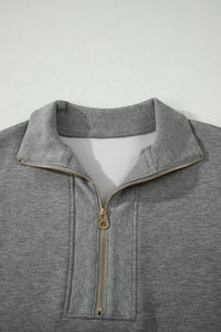 Polo zippé en maille gris pour femme: demi-zip et col côtelé