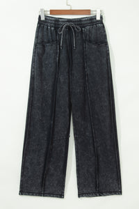 Pantalon large noir délavé minéral, taille élastique à cordon, poches plaquées, coutures brutes