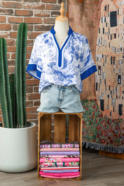 Women's V-neck top with contrast raglan sleeves and blue abstract print
