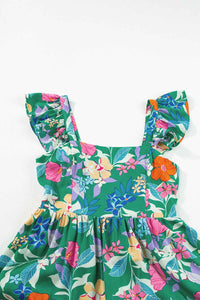 Robe longue florale verte, encolure carrée, volants d’épaules et taille froncée.