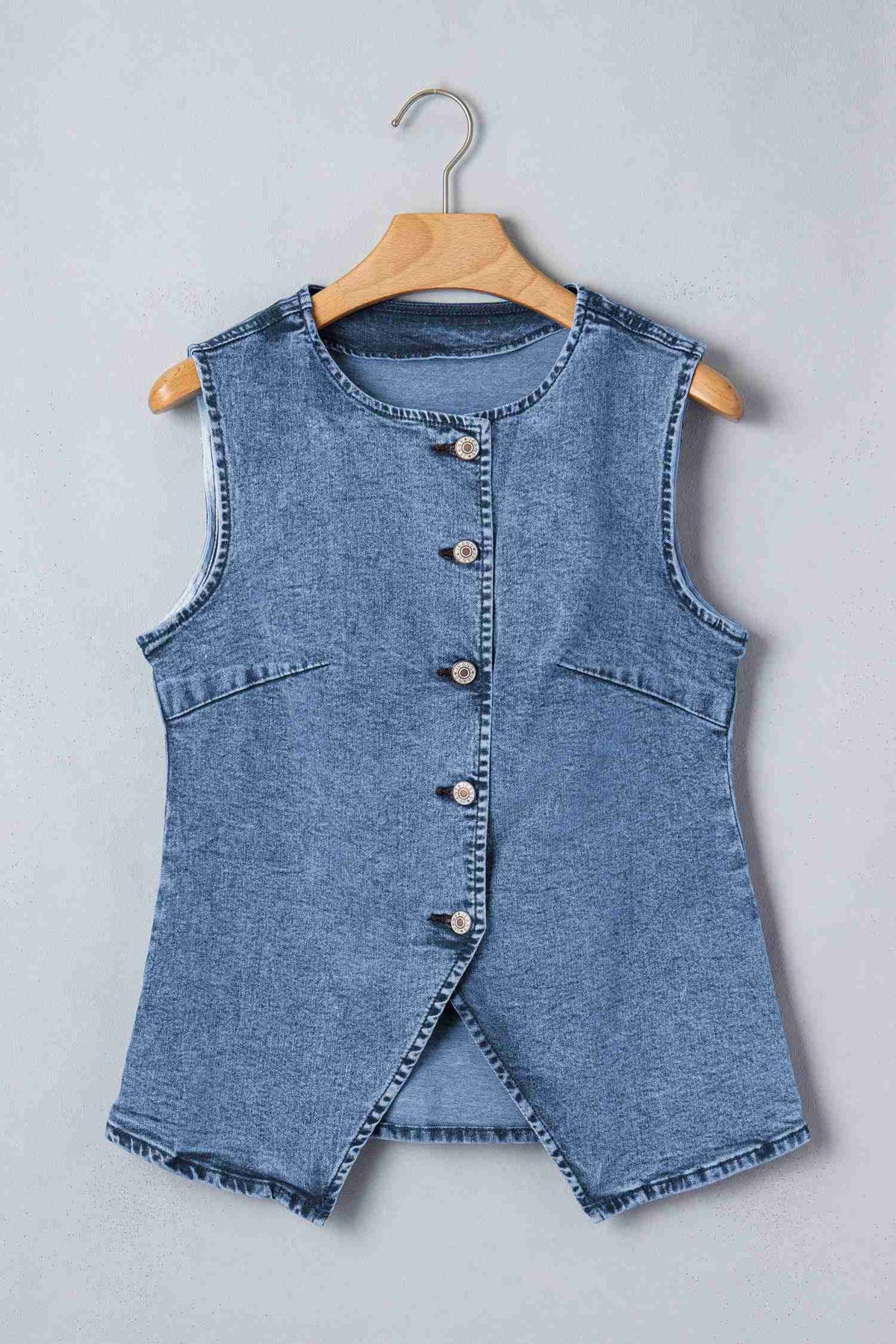 Gilet en denim bleu sans manches, boutonnage devant, coupe fendue au bas, sur cintre