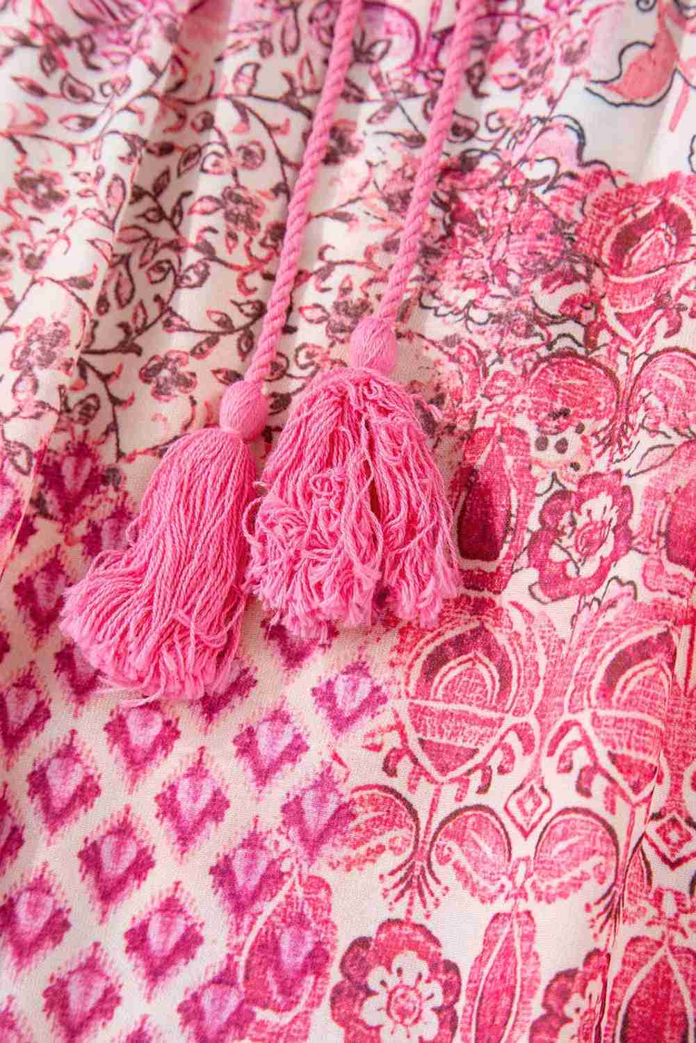 Jupe longue bohème rouge rosé avec pompons tassels, motifs cachemire détaillés