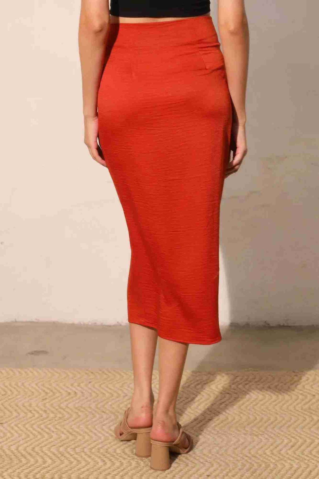 Jupe midi portefeuille satin crêpe lavé rouge, coupe droite avec fente centrale.