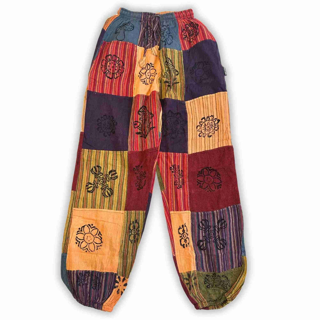 Pantalon ample patchwork multicolore avec motifs, jambe large et ceinture élastique.