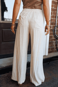 Pantalon large femme écru à taille élastique, poches latérales et plis au devant