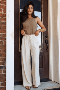 Pantalon large femme écru à taille élastique et lien, patte boutonnée sur le devant