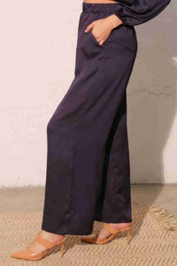Pantalon satiné fluide marine foncé, vue de profil, taille élastique, jambe large.