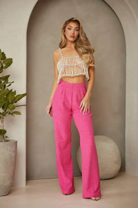Pantalon fuchsia taille haute en tissu terry texturé, jambes larges.
