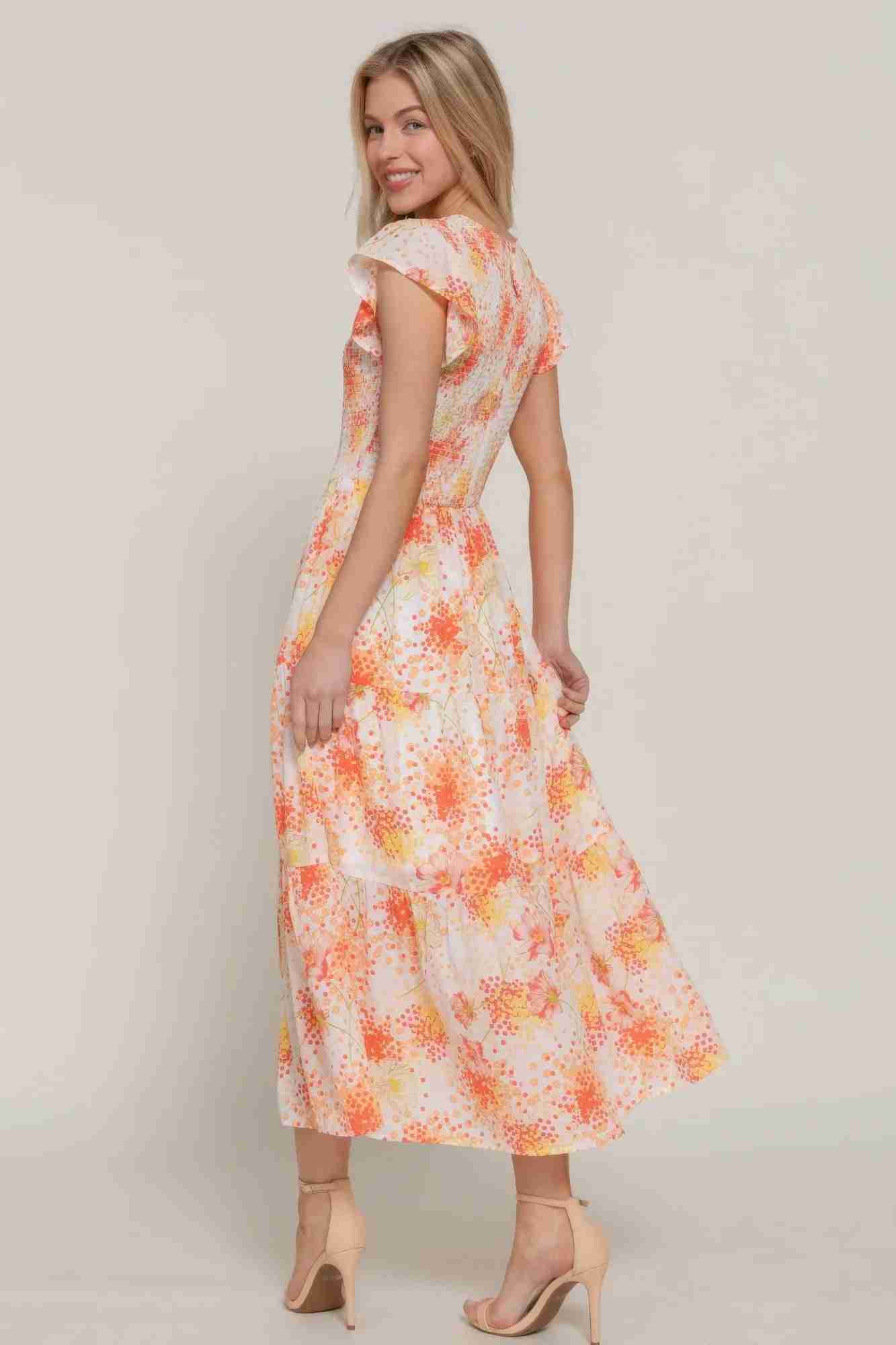 Robe florale smockée ivoire à manches à volants, vue de côté motifs orange
