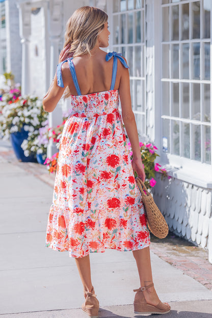 Robe midi imprimée floral rouge vue de dos, bretelles à nœuds bleus, taille haute.