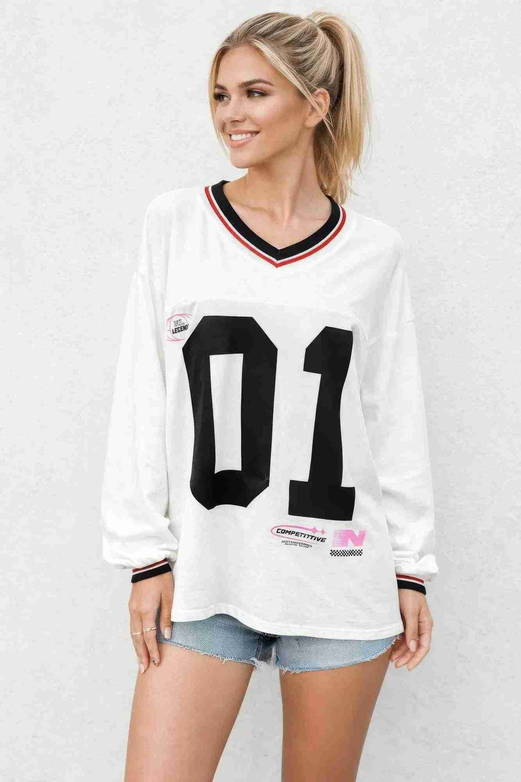 Haut varsity femme blanc à manches longues, encolure contrastée et grand 11 noir