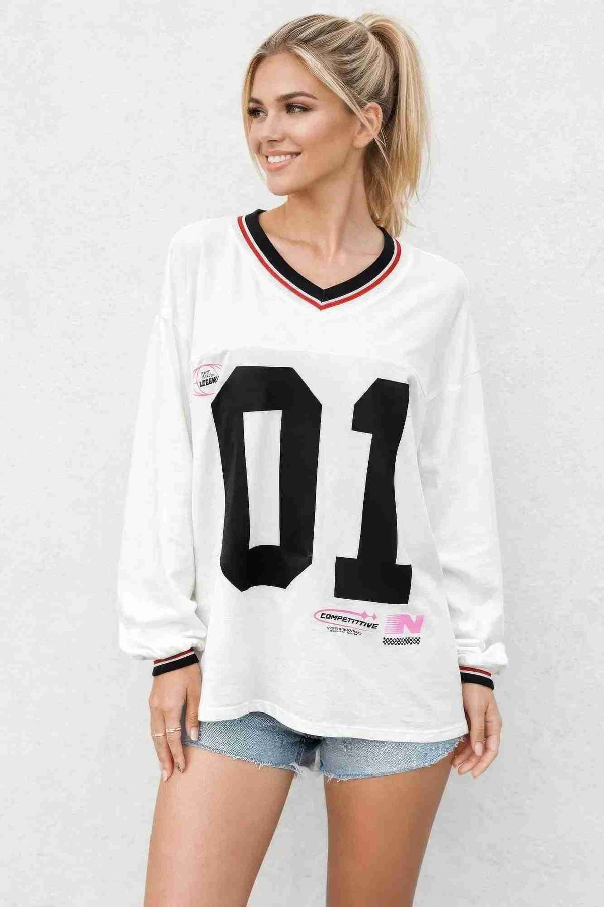 Haut varsity femme blanc à manches longues, encolure contrastée et grand 11 noir